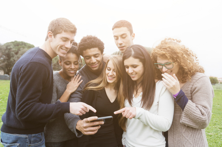 Multiethnic Group of Friends Looking at Mobile Phone